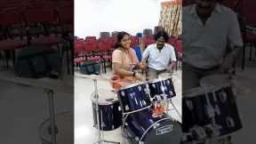 Girl playing drums rolls