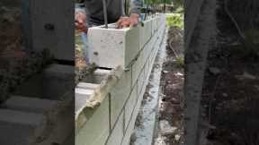 Installing some 8x8x16 CMU blocks for a decretive fence wall