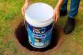 Drop the old paint bucket into the
